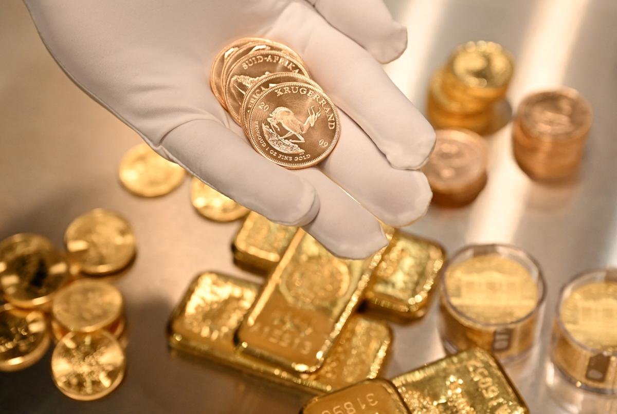 Gold bars and coins on a financial chart