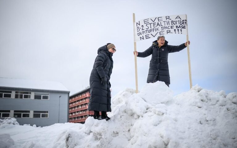 Greenland flag with Danish flag in background